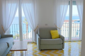 Junior Studio Suite, Balcony, Sea View | Living area | 28-inch flat-screen TV with satellite channels, TV