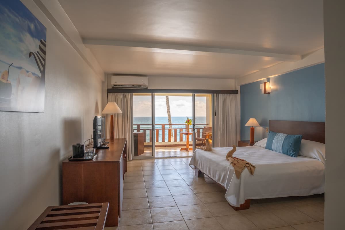 ocean front (beachfront room) | minibar, in-room safe, desk, cots/infant beds