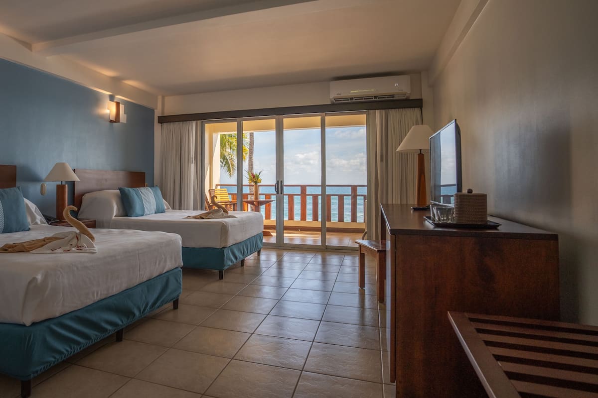 ocean front (beachfront room, 2 queen beds) | minibar, in-room safe, desk, cots/infant beds