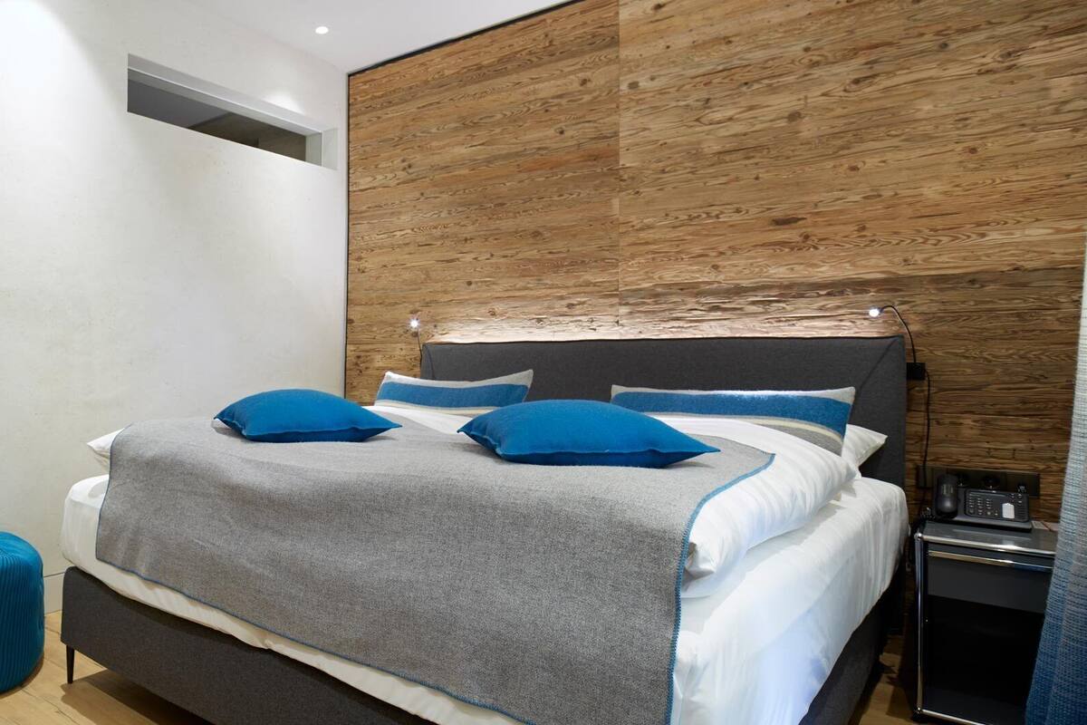 Ein Schlafzimmer mit einem Bett, einem Nachttisch und einem kleinen Schreibtisch mit Stuhl.