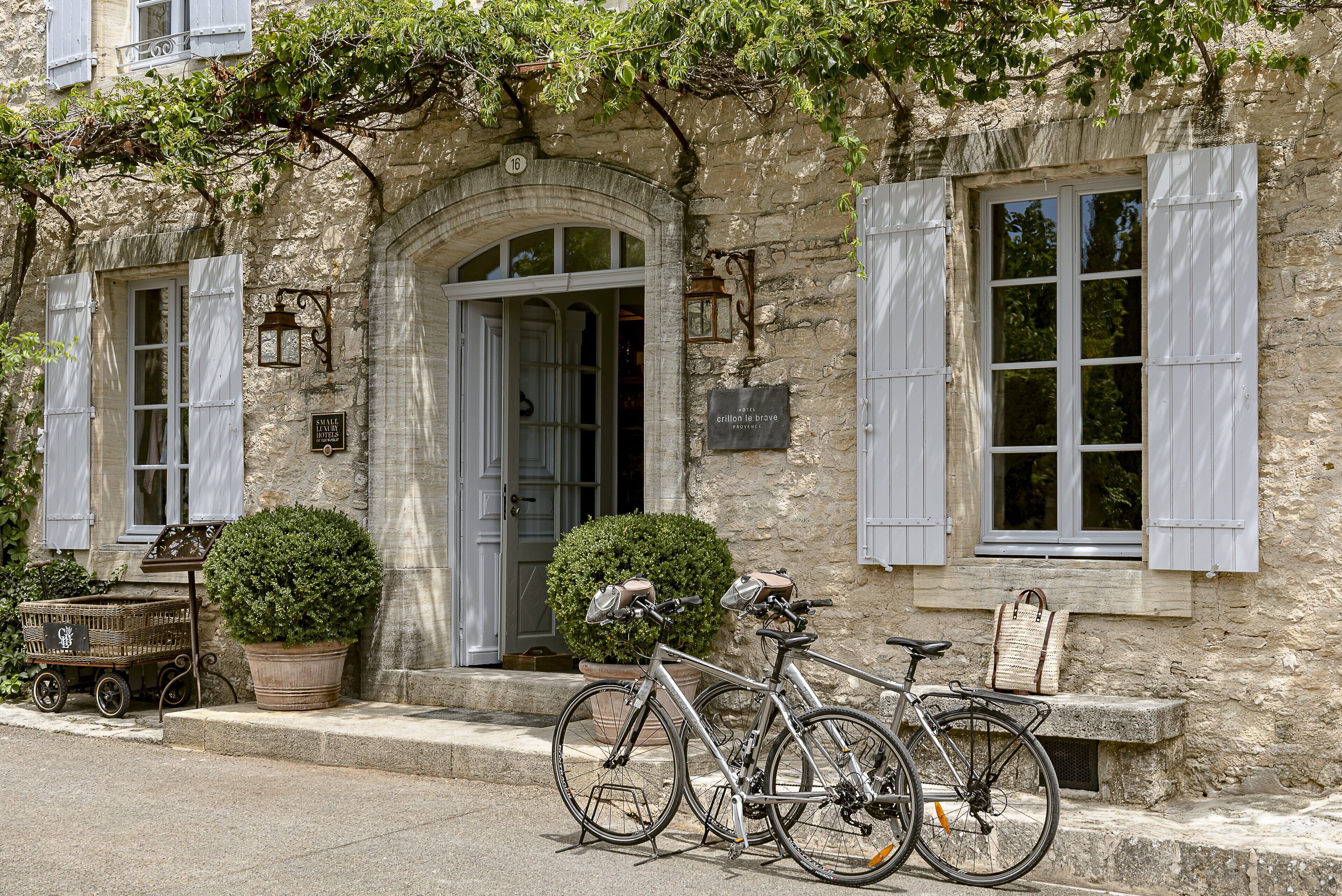 A stone building with a door, windows, and a bicycle parked outside.