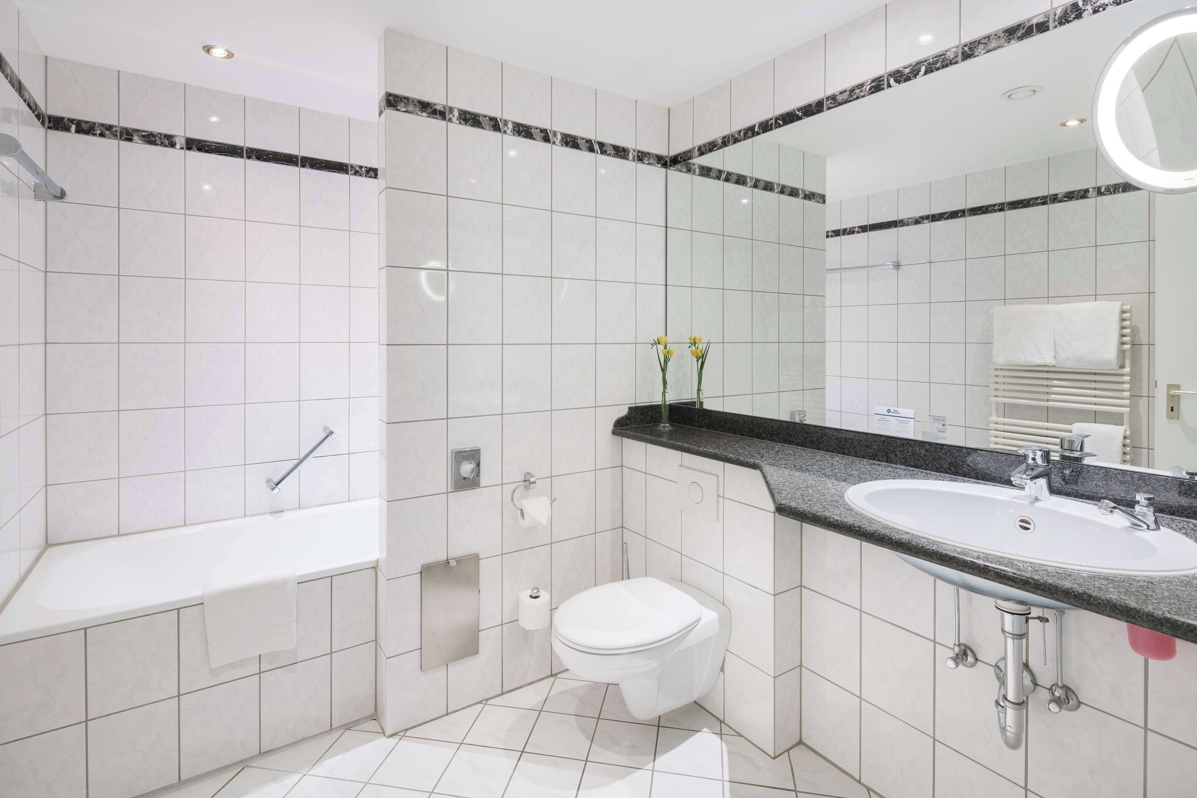 bathtub, hair dryer, towels, soap