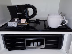 Een koffiezetapparaat, een mok en een keypad-slot op een aanrecht.