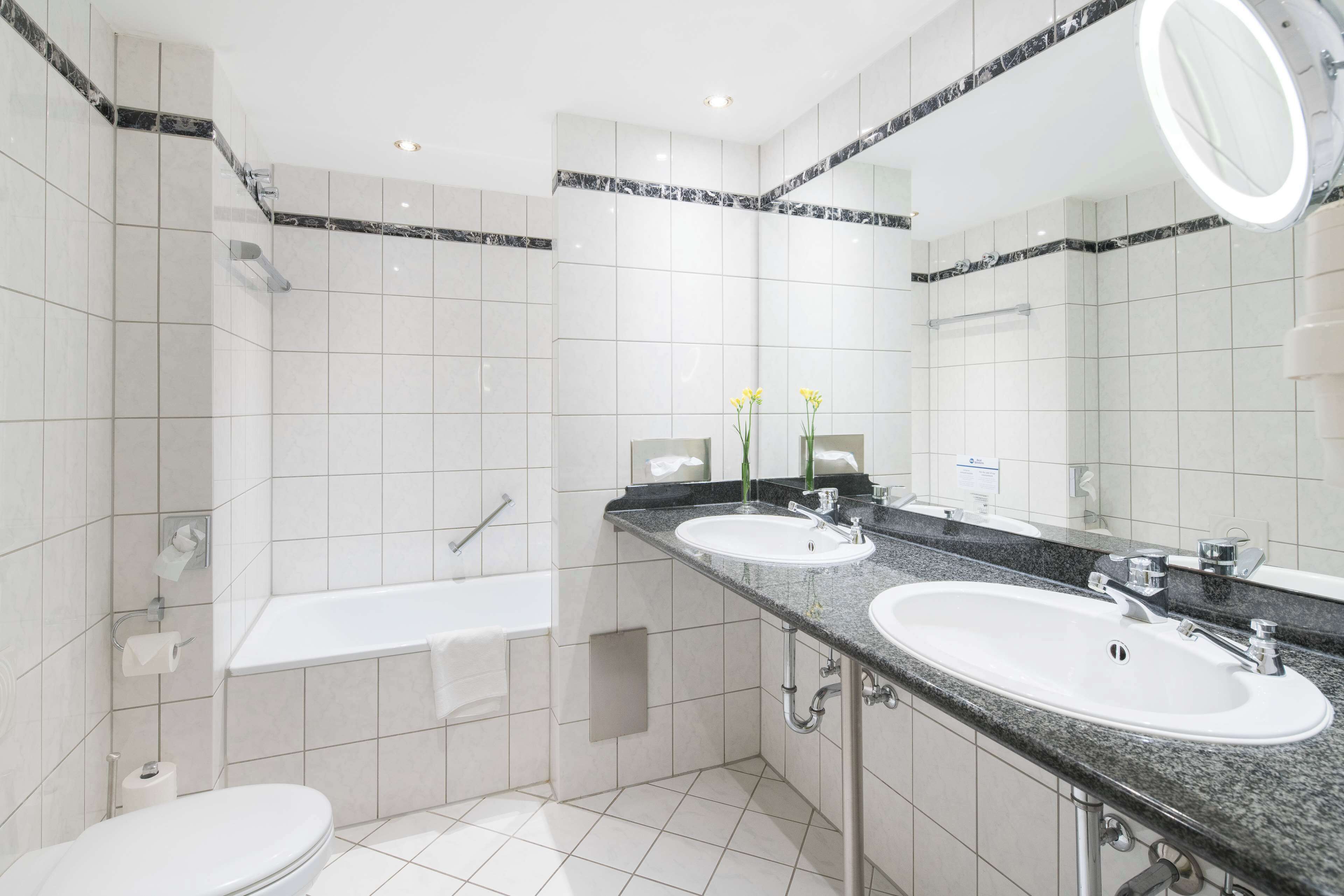 bathtub, hair dryer, towels, soap