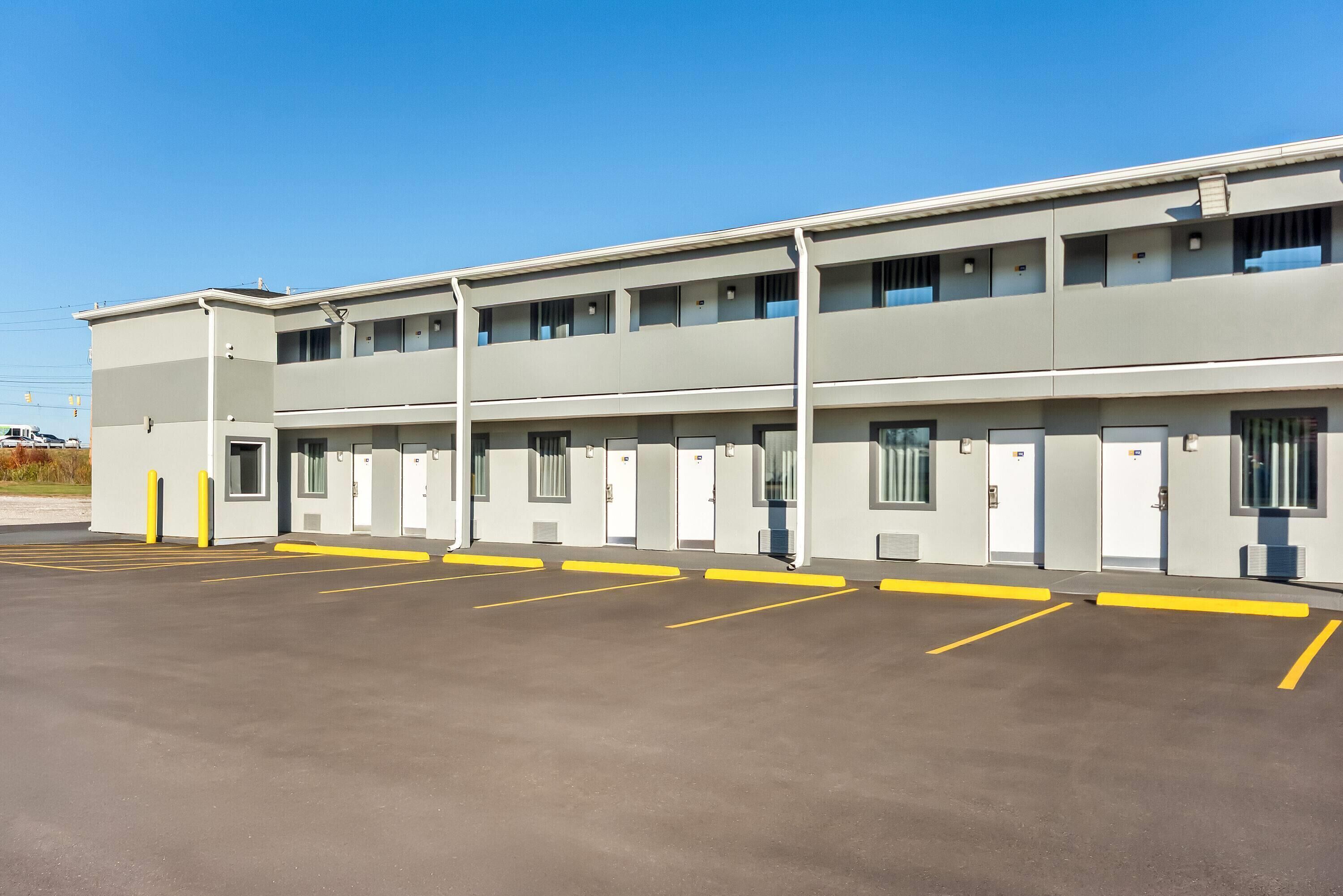 A multi-story motel with a parking lot.