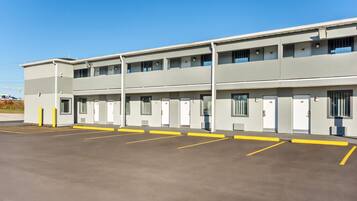 A multi-story motel with a parking lot.
