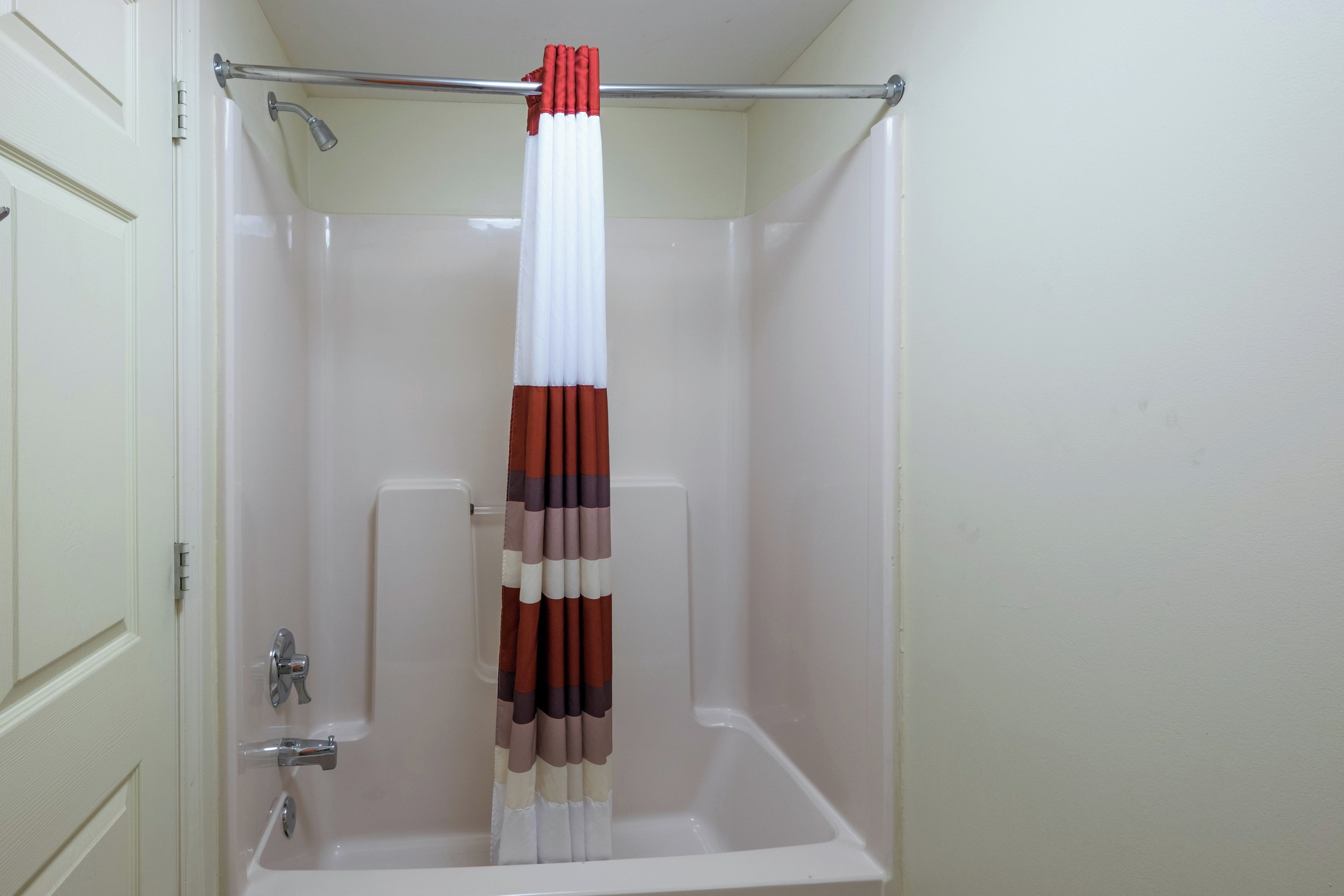A bathroom with a bathtub, a shower, and a toilet.