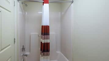 A bathroom with a bathtub, a shower, and a toilet.