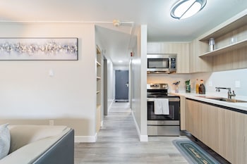 Elite Suite, 1 King Bed with Sofa bed, Courtyard View | Private kitchen | Fridge, microwave, oven, stovetop at Interurban Suites Hotel