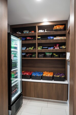 A storage area with shelves stocked with snacks and beverages.
