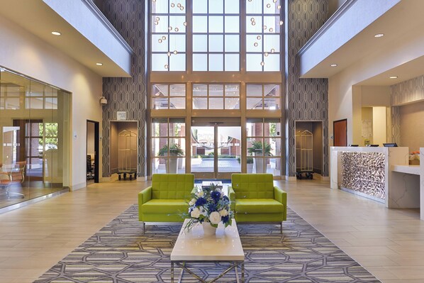A spacious lobby with a high ceiling, large windows, and a reception desk. - Holiday Inn Express & Suites Elk Grove Central - Hwy 99 by IHG (Elk Grove)