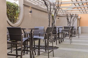 Outdoor seating with wicker chairs and tables, arranged in rows. - Holiday Inn Express & Suites Elk Grove Central - Hwy 99 by IHG (Elk Grove)