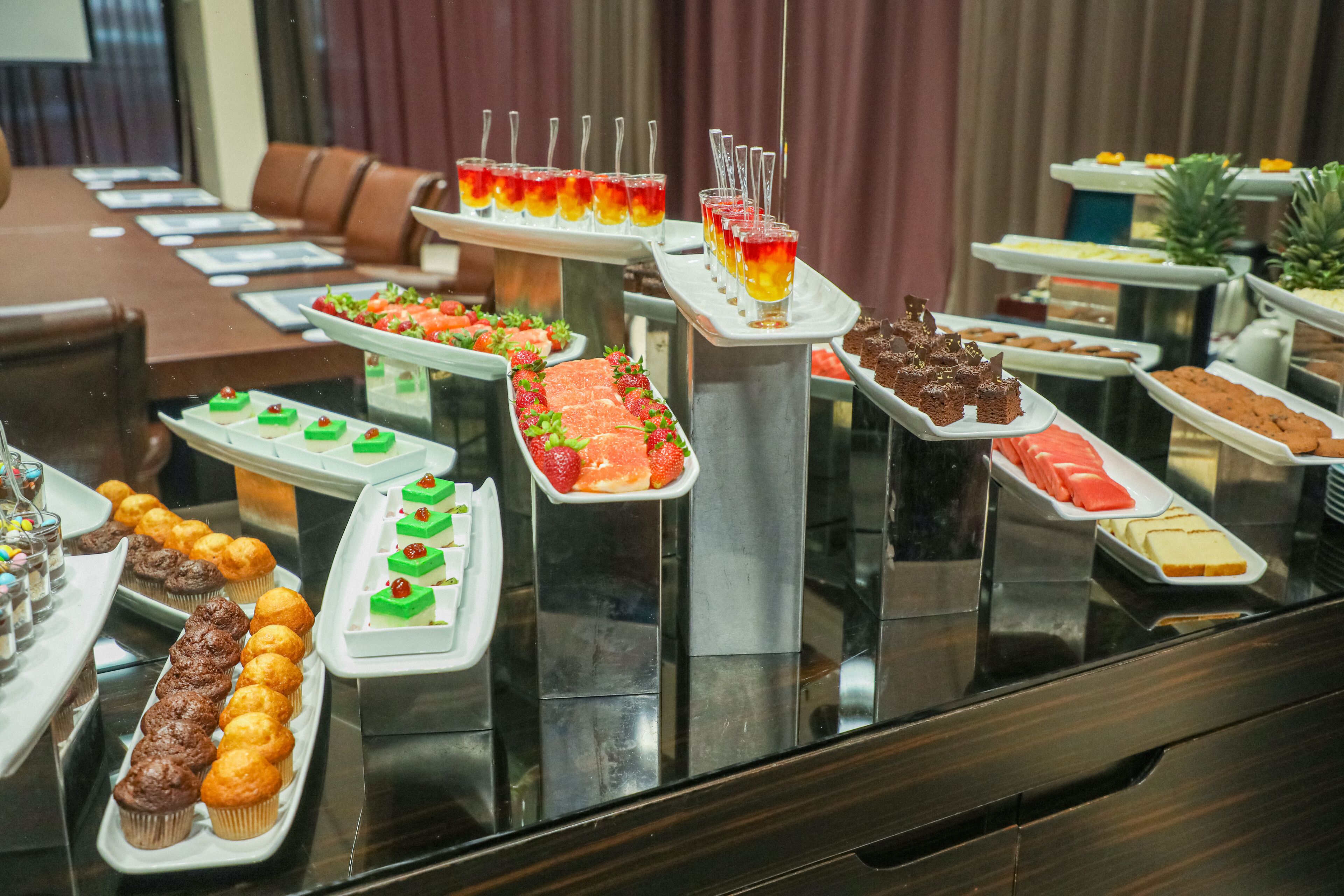 A buffet with various food items and drinks.