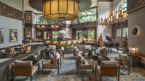A spacious lobby with a bar area, seating arrangements, and a grand piano. - Conrad Bangkok (Bangkok)