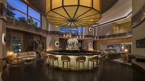 A spacious lobby with a central bar area, high ceilings, and large windows. - Conrad Bangkok (Bangkok)