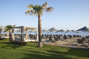 On the beach, sun-loungers, beach umbrellas, beach towels