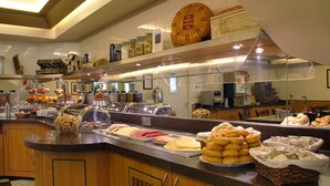 A buffet with various food items and condiments. - Hotel Avenue (Amsterdam)