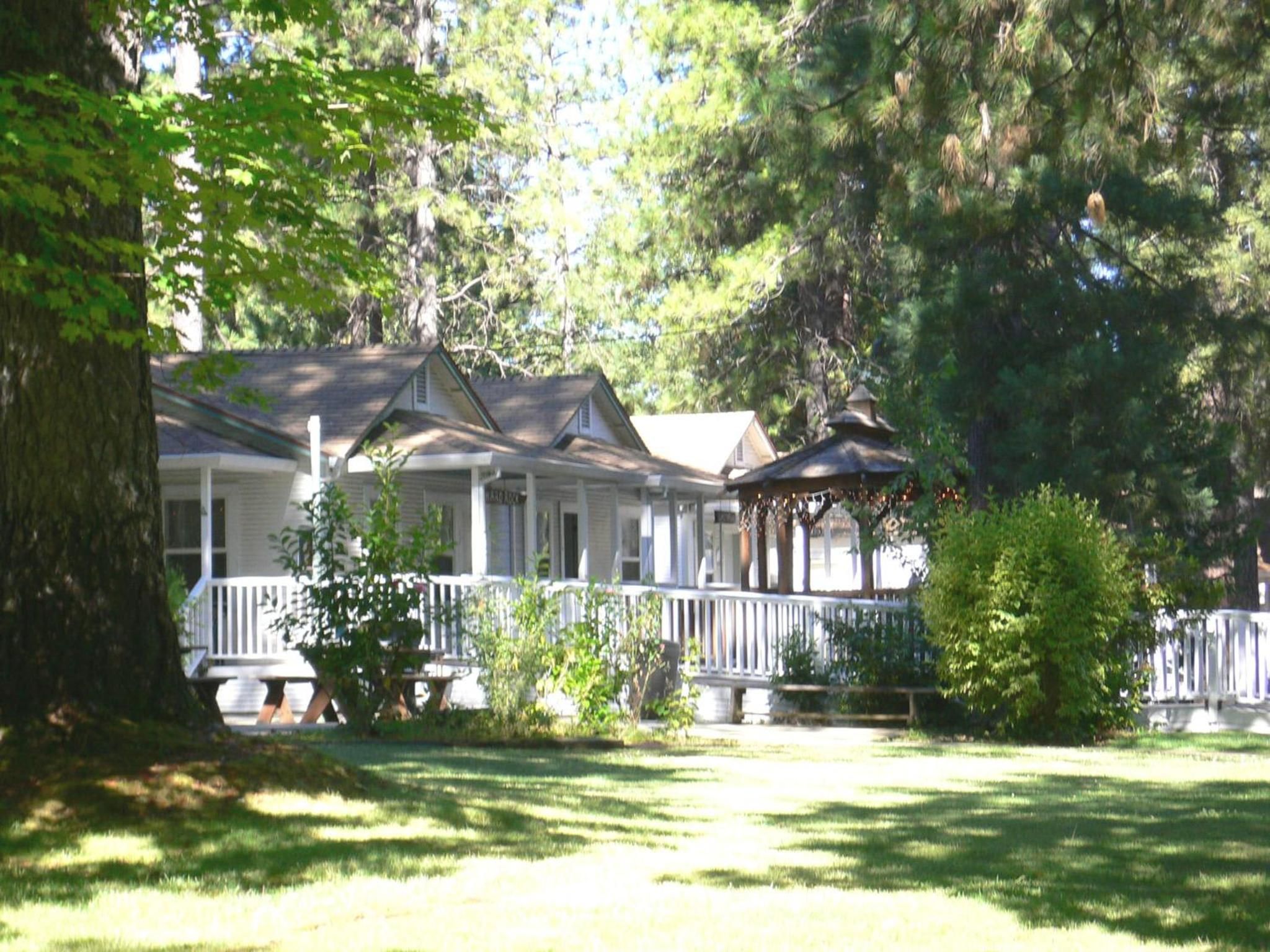 A two-story house with a porch and a gazebo.