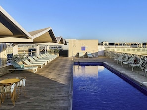 Seasonal outdoor pool, open noon to 8:00 PM, pool umbrellas
