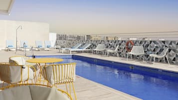 Seasonal outdoor pool, open noon to 8:00 PM, pool umbrellas