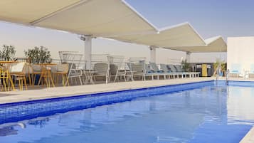 Seasonal outdoor pool, open noon to 8:00 PM, pool umbrellas
