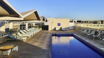 Seasonal outdoor pool, open noon to 8:00 PM, pool umbrellas