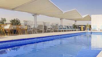 Seasonal outdoor pool, open noon to 8:00 PM, pool umbrellas