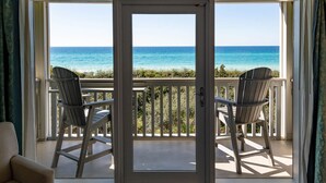 A balcony with two Adirondack chairs facing a clear view of the ocean. - WaterColor Inn & Resort (Santa Rosa Beach)