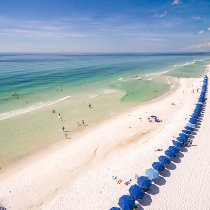 On the beach, white sand, sun loungers, beach umbrellas