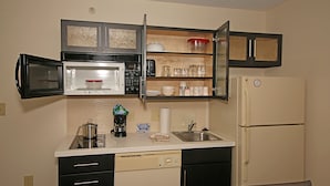 A compact kitchen with a microwave, coffee maker, and a refrigerator. - Candlewood Suites Newport News/Yorktown by IHG (Yorktown)
