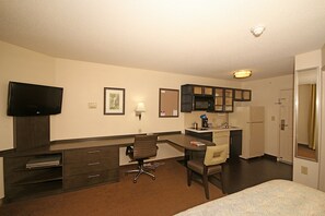 A hotel room with a desk, chair, television, and a bed. - Candlewood Suites Newport News/Yorktown by IHG (Yorktown)