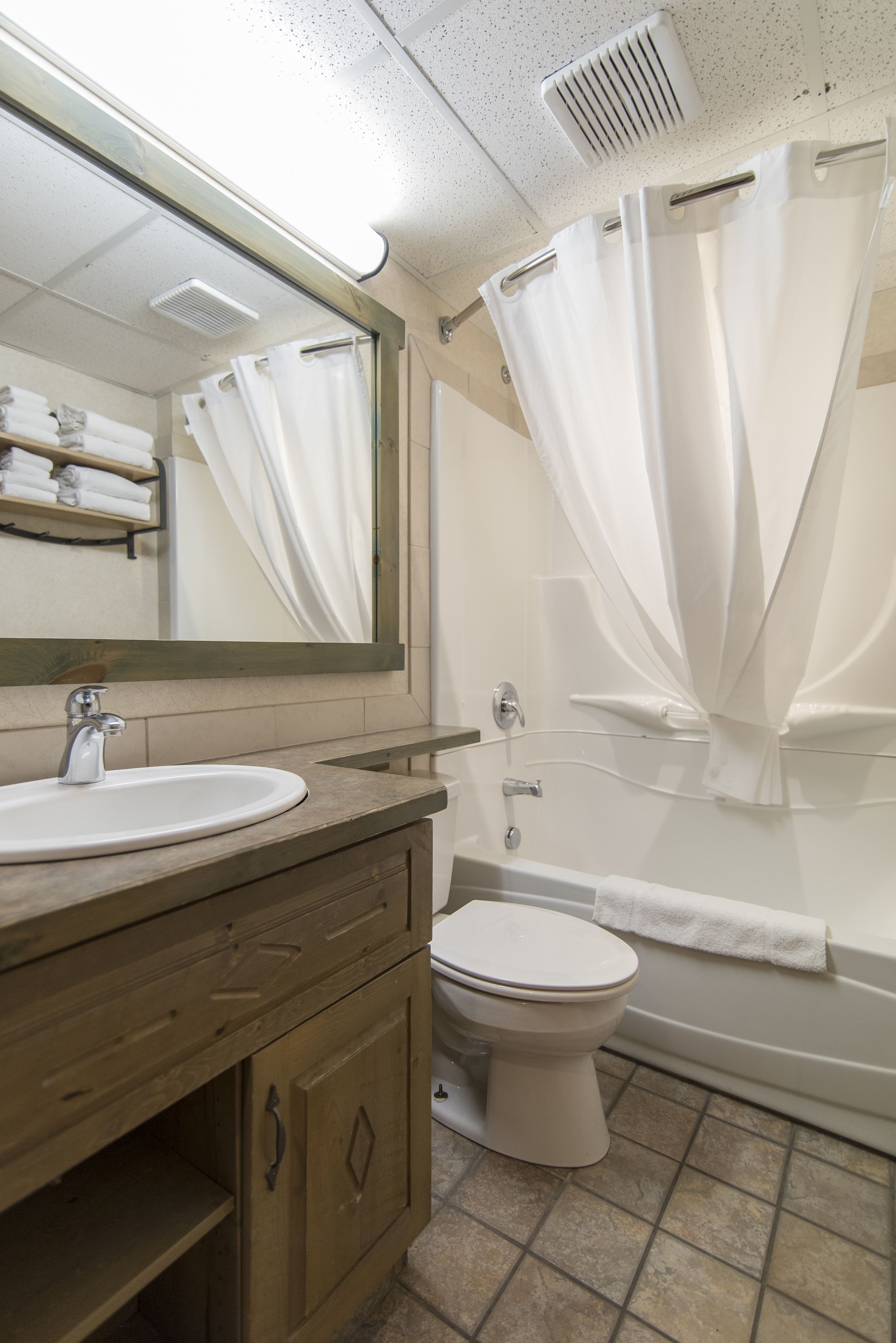 A bathroom with a sink, toilet, and bathtub.