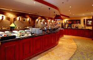A buffet with a variety of food items and a red bar counter. - Holiday Inn Al Khobar by IHG (Al Khobar)