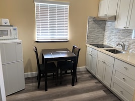 Desk, laptop workspace, blackout drapes, iron/ironing board