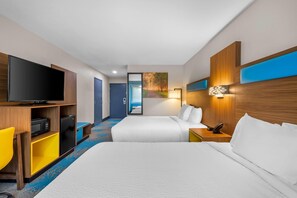 A hotel room with two beds, a TV, a desk with a computer, and a painting on the wall. - Days Inn & Suites by Wyndham Brandon Amphitheater (Brandon)