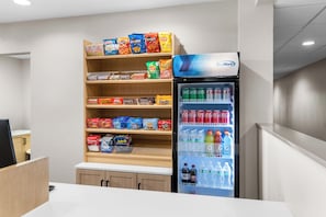 A snack and beverage vending area with a variety of snacks and drinks. - Days Inn & Suites by Wyndham Brandon Amphitheater (Brandon)