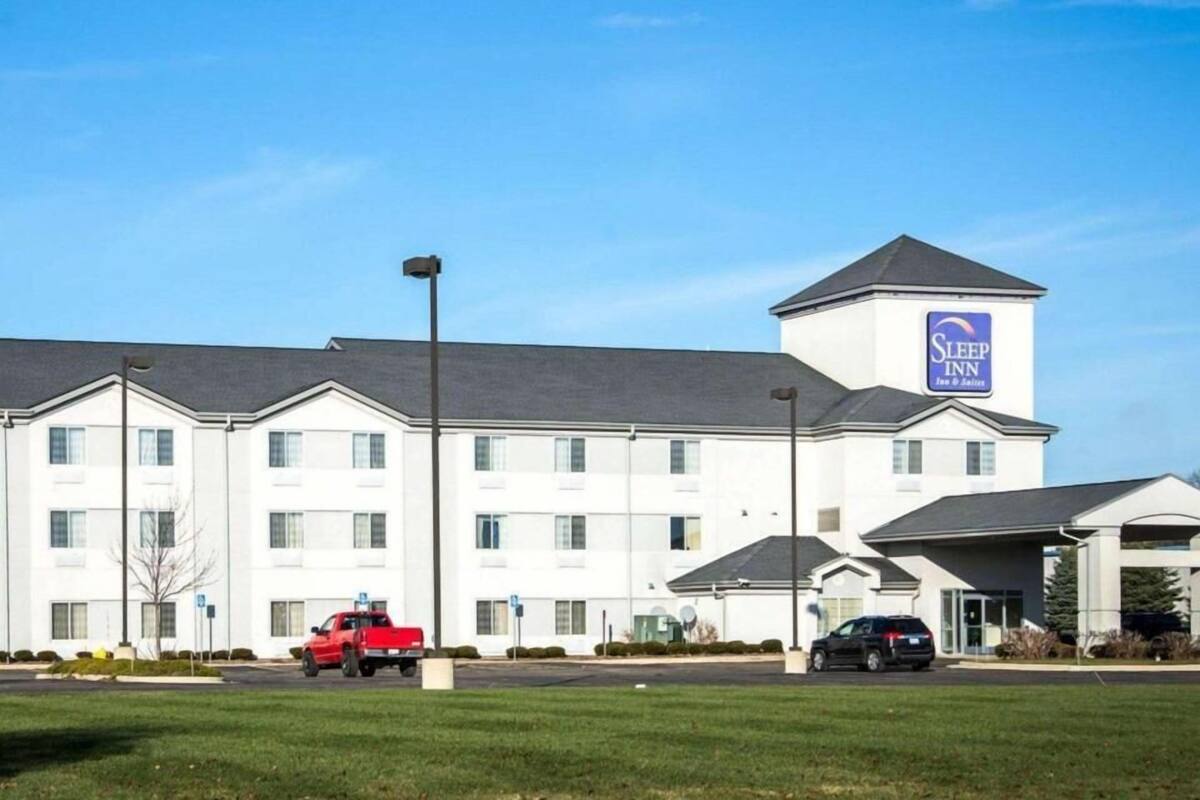 A multi-story hotel with a prominent sign for Sleep Inn.