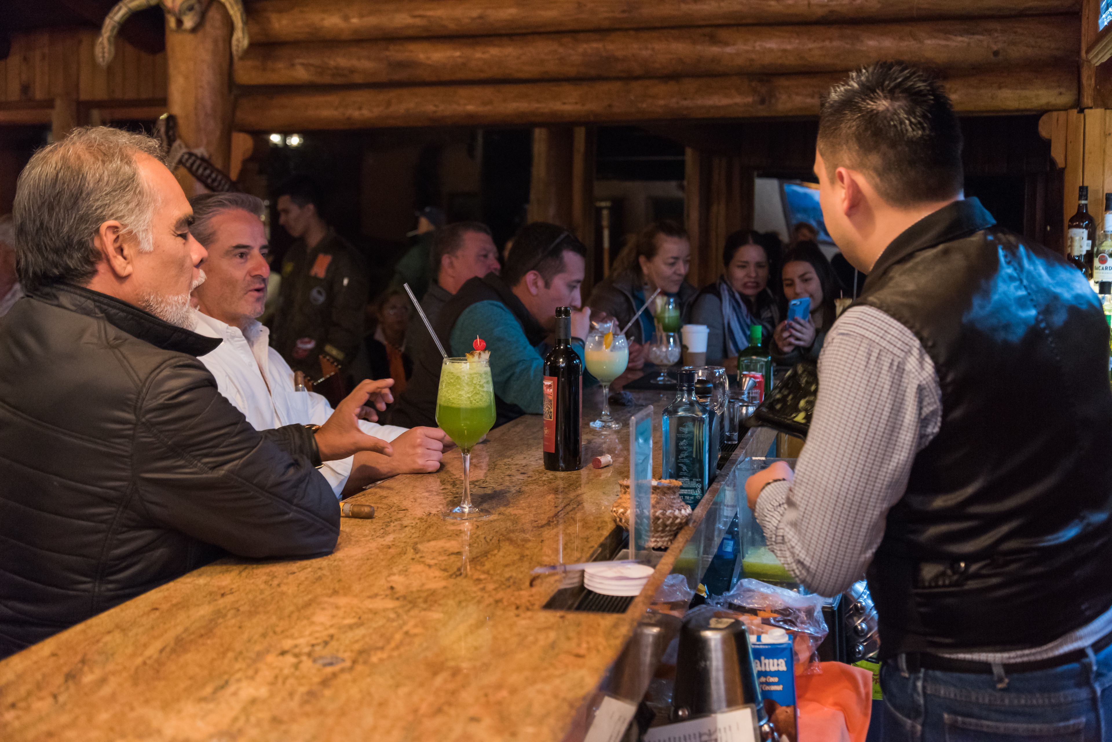 A bar area with a wooden interior and a marble countertop.