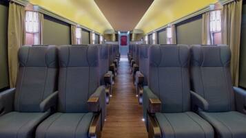 Travel in comfort with rows of plush seats and a central aisle for easy movement.
