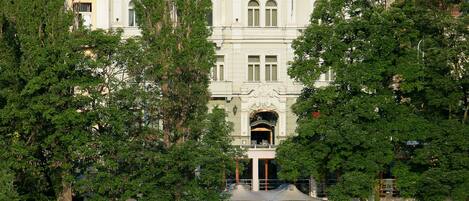 A multi-story hotel with a classic architectural style, featuring a prominent entrance with a canopy and a stone facade.
