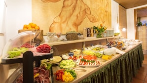 A buffet with various food items and a large mural on the wall. - Hotel Diana Feldberg (Feldberg)
