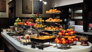 A buffet with various food items and a glass display case. - Grand Hotel Terminus (Bergen)