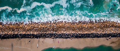 On the beach, white sand, sun-loungers, beach umbrellas