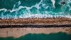 On the beach, white sand, sun-loungers, beach umbrellas