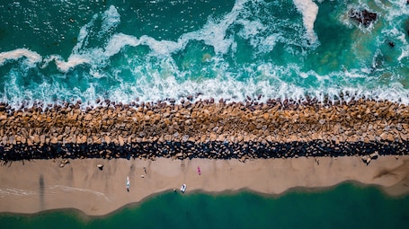 On the beach, white sand, sun loungers, beach umbrellas