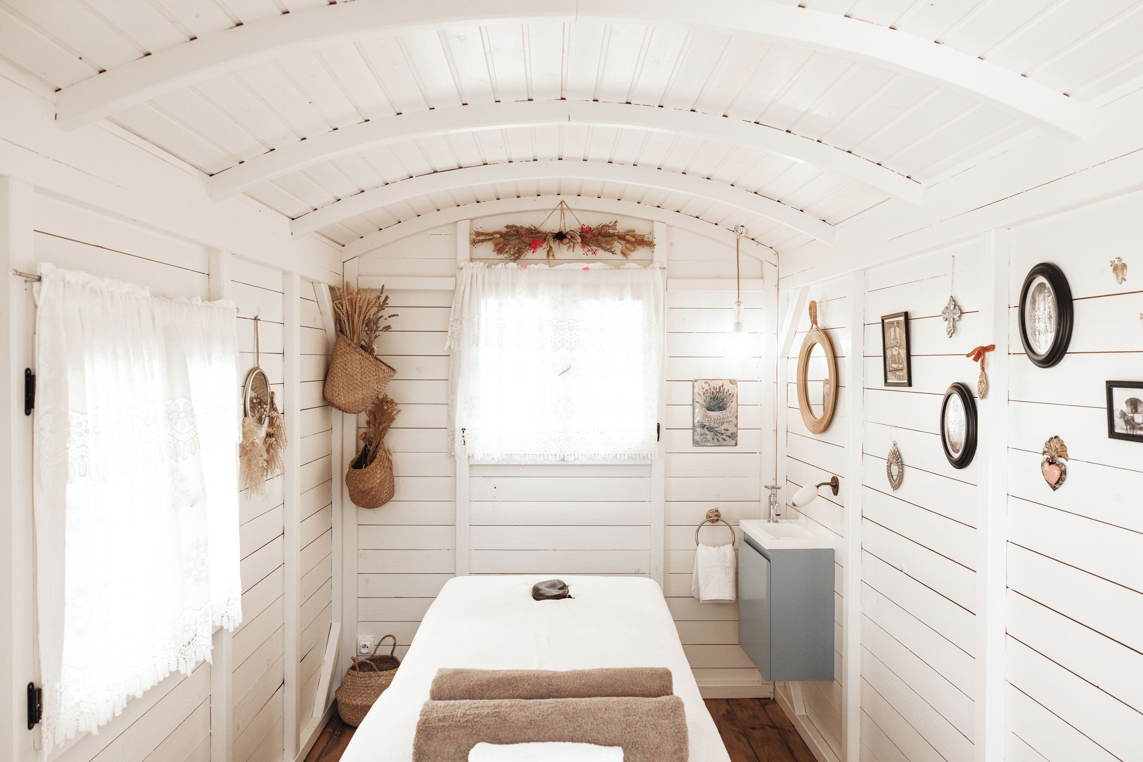 Une pièce comprenant un lit, un lavabo et des décorations murales.