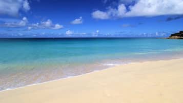 On the beach, white sand, sun-loungers, beach umbrellas