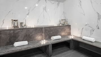 Bathroom features a vanity with mirror and bench seating, along with a tiled floor.