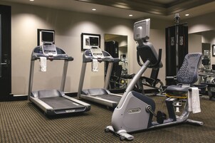 A hotel gym with treadmills, an elliptical, and weight machines.