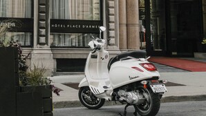 A historic building with ornate architecture, a white scooter parked in front, and the sign 'Hôtel Place d'armes' indicating a hotel. - Hotel Place d'Armes (Montreal)